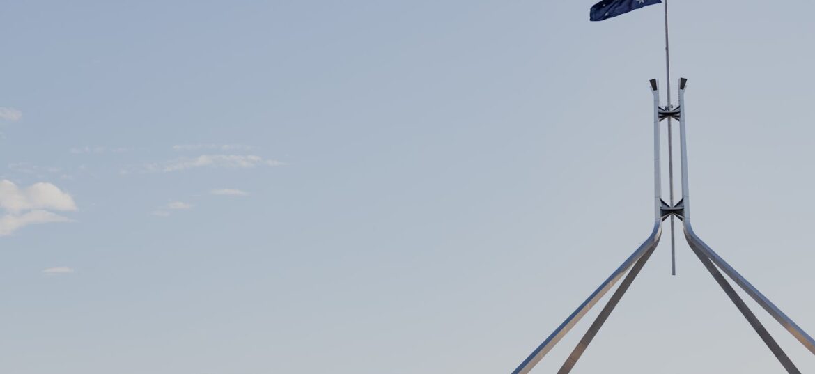 Australian flag flying over Parliament House in Canberra during the 2026 Federal Budget