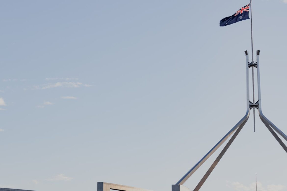 Australian flag flying over Parliament House in Canberra during the 2026 Federal Budget