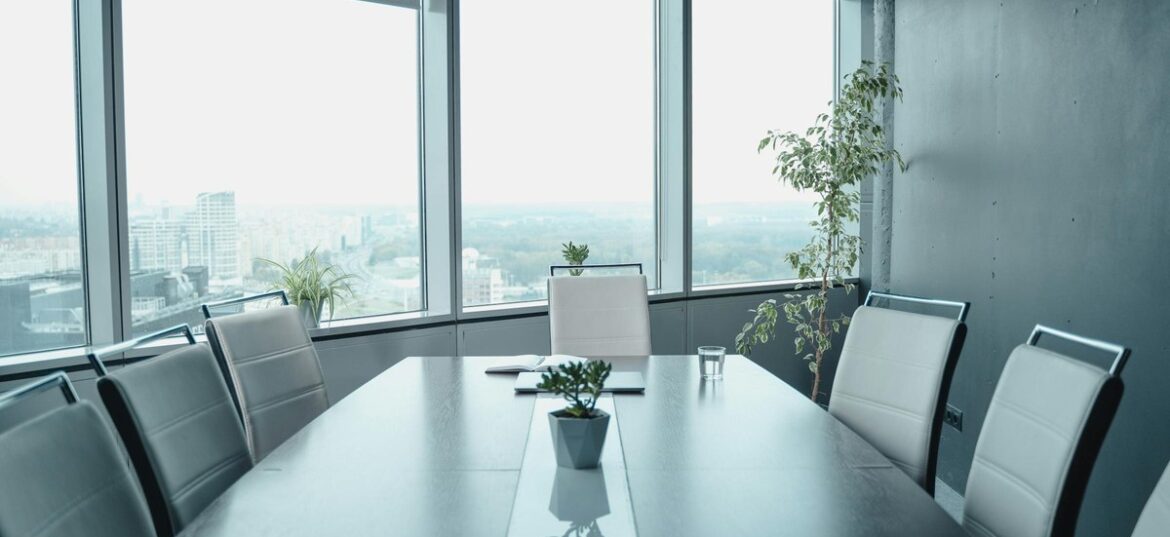Empty executive boardroom with panoramic city views, symbolising strategic restructure decisions facing Australian mid-market family business groups in 2026