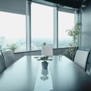 Empty executive boardroom with panoramic city views, symbolising strategic restructure decisions facing Australian mid-market family business groups in 2026