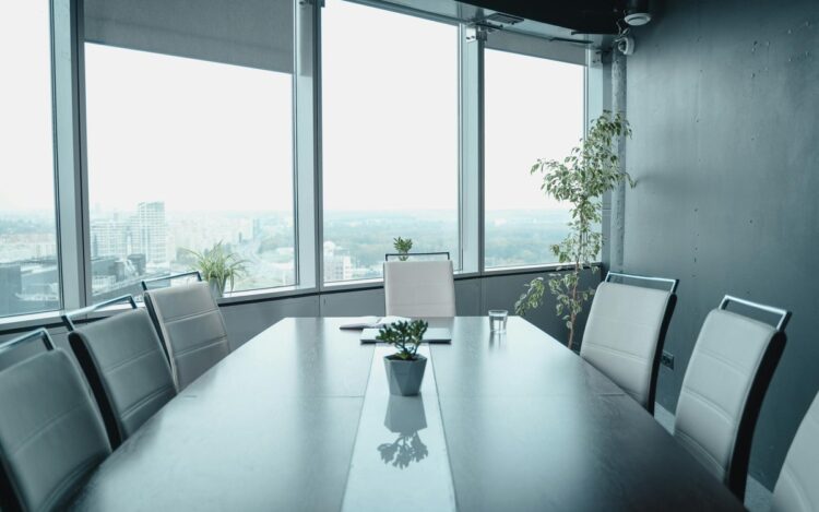 Empty executive boardroom with panoramic city views, symbolising strategic restructure decisions facing Australian mid-market family business groups in 2026