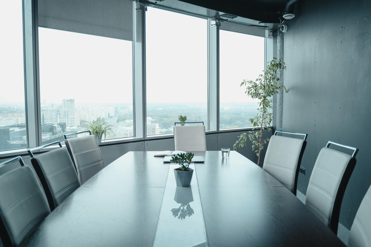 Empty executive boardroom with panoramic city views, symbolising strategic restructure decisions facing Australian mid-market family business groups in 2026