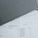 A laptop sitting on a spreadsheet of numbers — symbolising EOFY payroll finalisation and the Payday Super transition for Australian small business employers