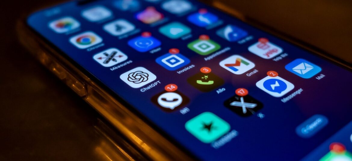 A smartphone screen full of app icons with red notification badges — symbolising the digital platforms the ATO now automatically receives data from under the Sharing Economy Reporting Regime