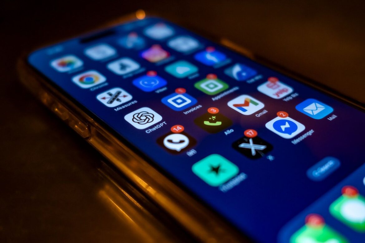A smartphone screen full of app icons with red notification badges — symbolising the digital platforms the ATO now automatically receives data from under the Sharing Economy Reporting Regime