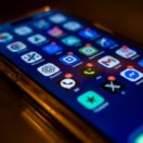 A smartphone screen full of app icons with red notification badges — symbolising the digital platforms the ATO now automatically receives data from under the Sharing Economy Reporting Regime