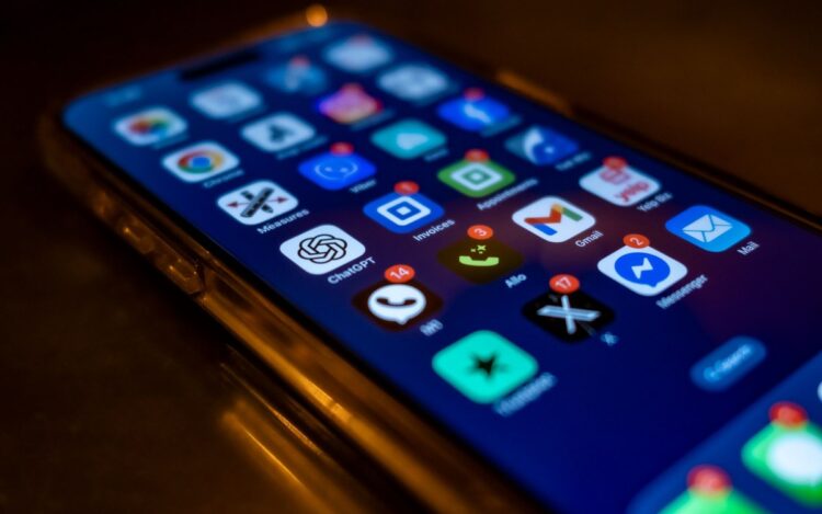 A smartphone screen full of app icons with red notification badges — symbolising the digital platforms the ATO now automatically receives data from under the Sharing Economy Reporting Regime