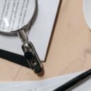 Reviewing tax documents with a magnifying glass to find commonly missed deductions