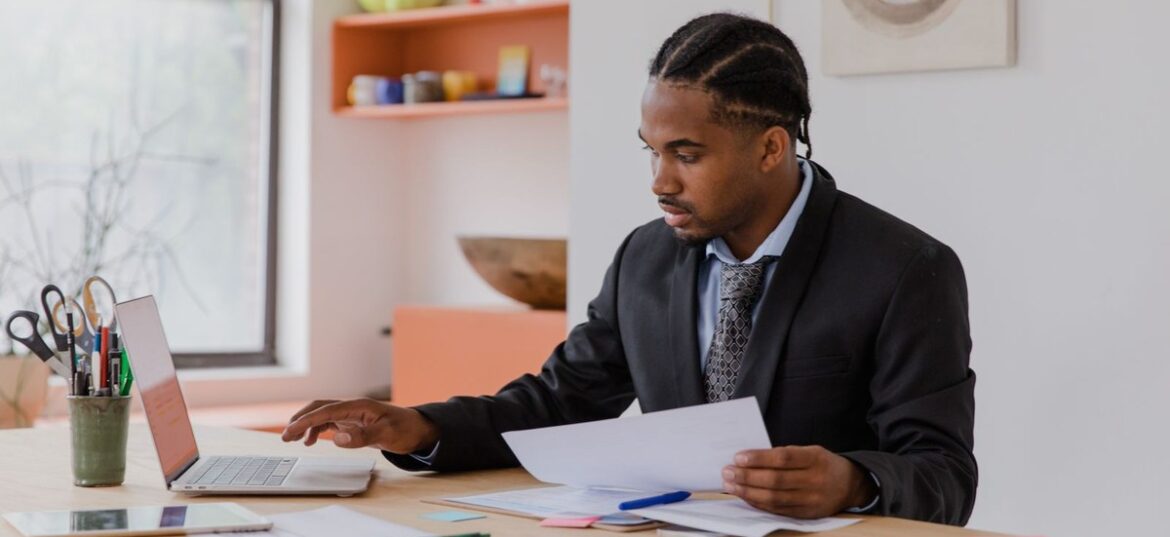 Australian small business owner reviewing documents at a desk while choosing between a sole trader and company structure