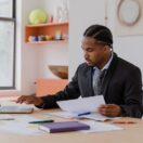 Australian small business owner reviewing documents at a desk while choosing between a sole trader and company structure