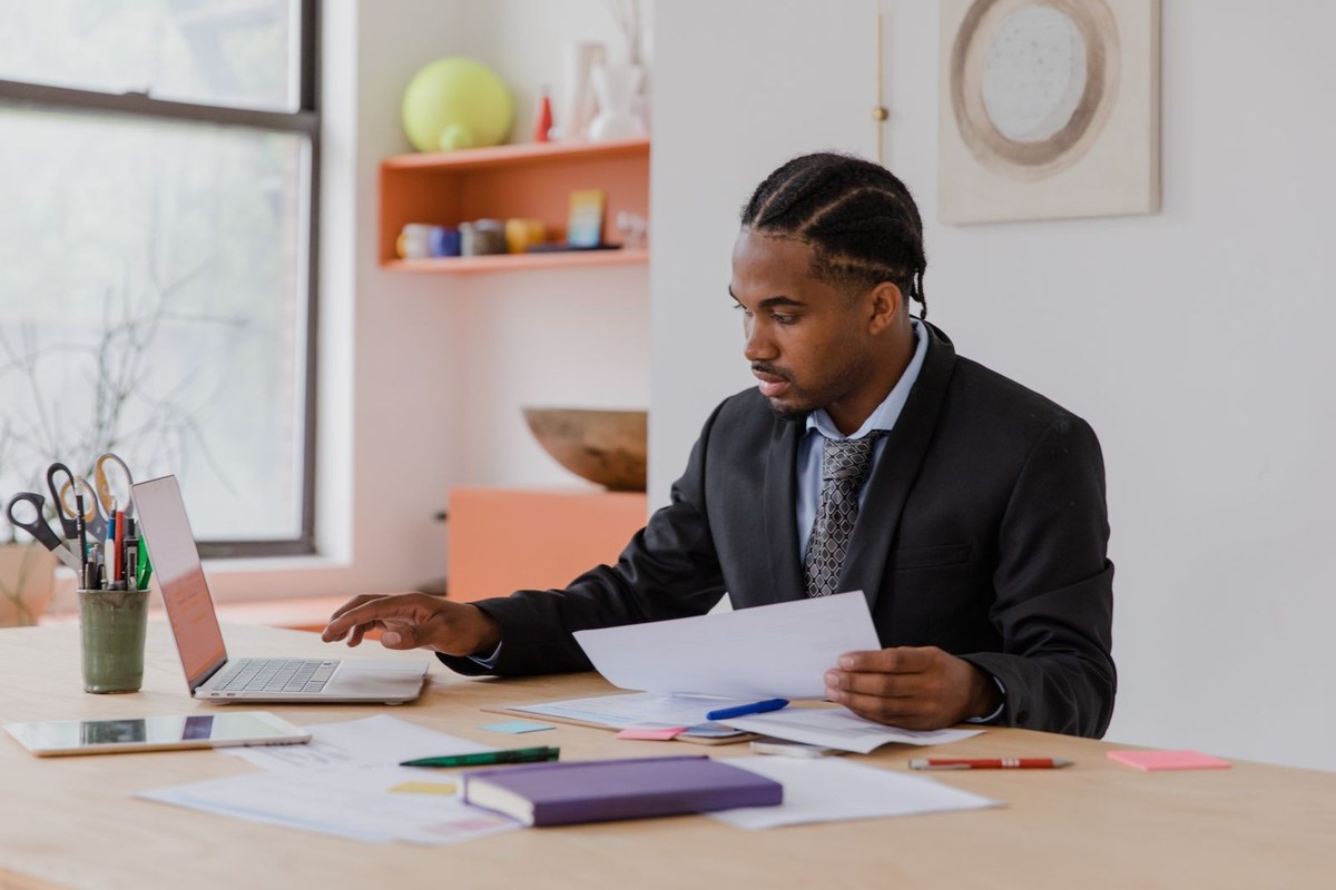 Small business owner reviewing paperwork at a desk, weighing up a sole trader versus company structure in Australia