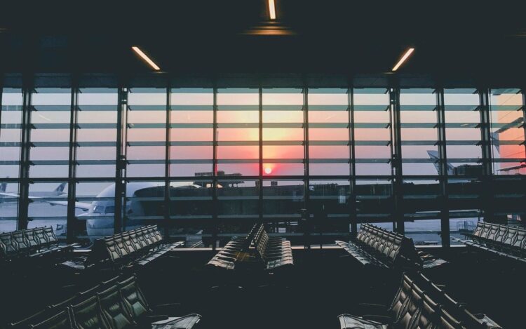 Empty airport departure lounge at sunset, Australian tax residency for people working overseas, Wiselink Accountants