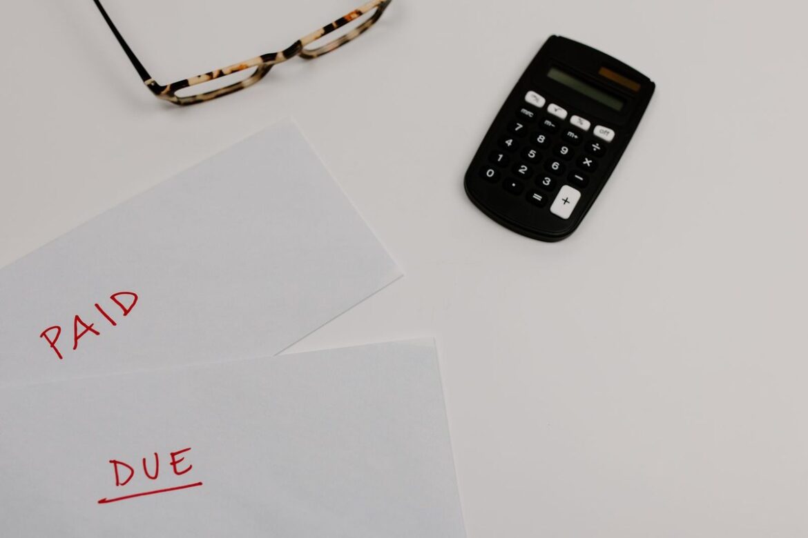 Envelopes marked paid and due beside a calculator, representing a PAYG instalment notice due 28 October 2026, Wiselink Accountants Melbourne and Brisbane