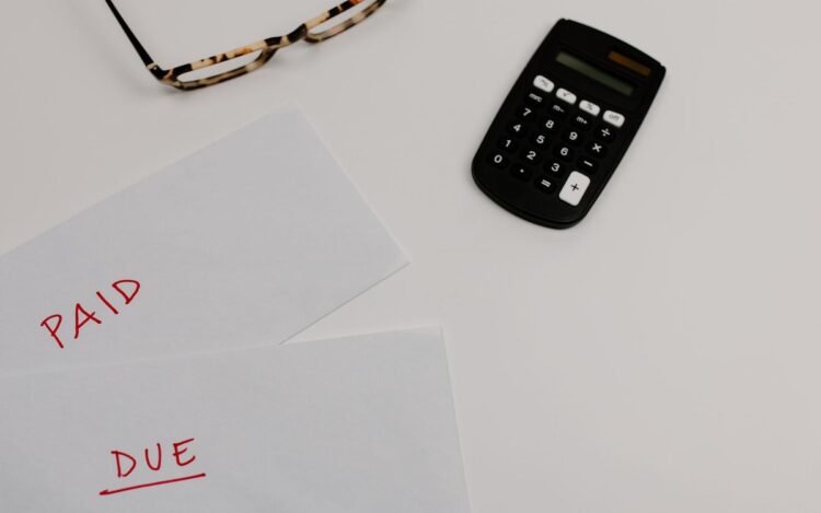 Envelopes marked paid and due beside a calculator, representing a PAYG instalment notice due 28 October 2026, Wiselink Accountants Melbourne and Brisbane
