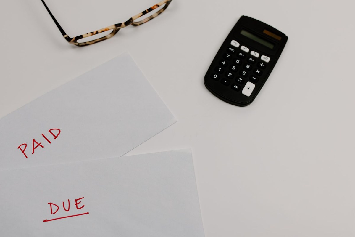 Envelopes marked paid and due beside a calculator, representing a PAYG instalment notice due 28 October 2026, Wiselink Accountants Melbourne and Brisbane