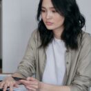 Woman at a desk holding a credit card while paying online on a laptop: ATO credit card payments extended to 30 June 2027