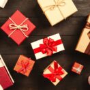 Wrapped gift boxes with red ribbons on a wooden table: FBT and tax rules for staff Christmas gifts and parties, Wiselink Accountants Melbourne and Brisbane