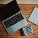 Laptop, calculator and notebook on a wooden desk: checking Payday Super contributions before 28 October 2026